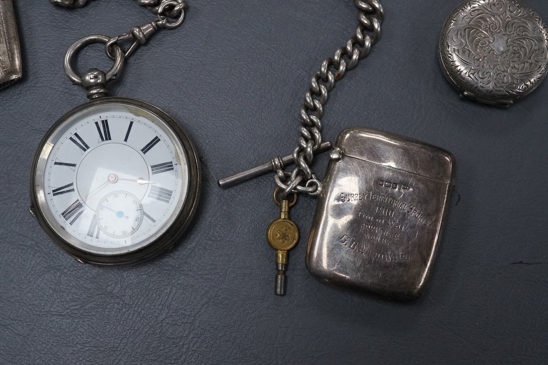 A late Victorian silver open faced key wind pocket watch, with Roman dial and subsidiary seconds, case diameter 52mm, on a heavy silver curb link albert, hung with a silver vesta case and a watch key, together with a con